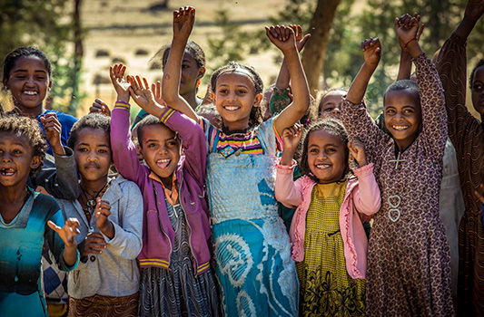 Happy kids with hands raised in excitement