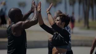 LES MILLS GRIT™ coaches Sheldon and Nikki share a moment on the blacktop