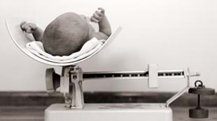  Newborn baby on scales